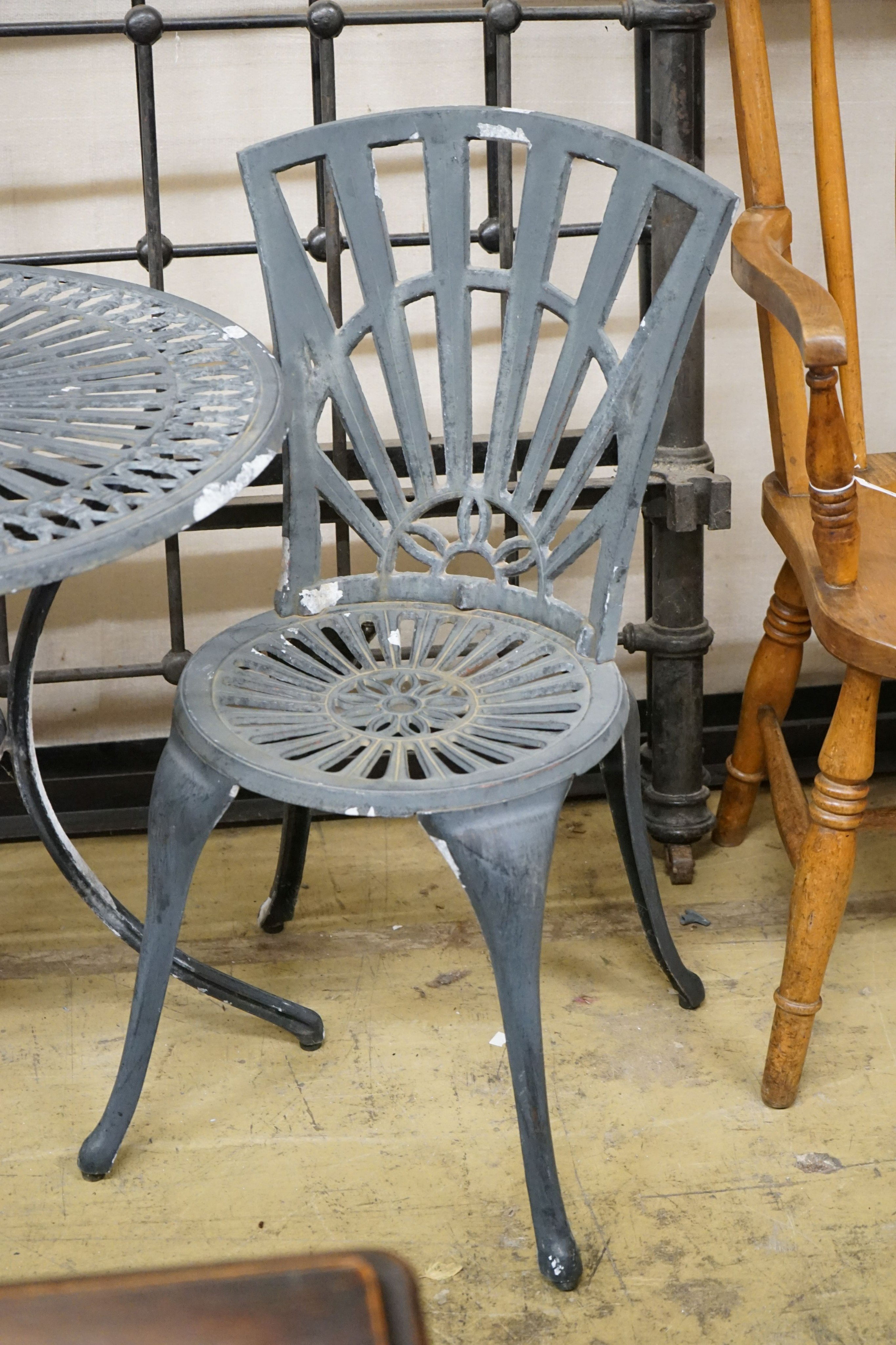 A painted aluminium circular garden table, diameter 69cm, height 66cm and two chairs